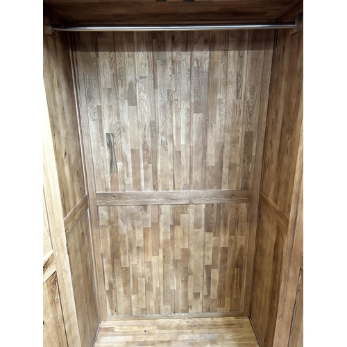 1 - A modern oak double wardrobe - approx. 193cm high x 109cm wide x 58cm deep