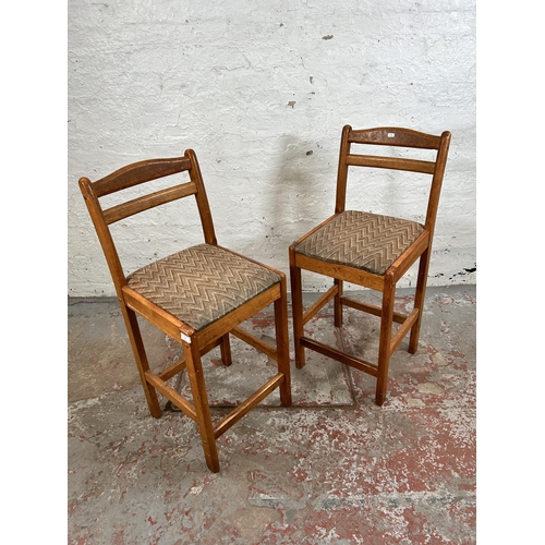 18 - A pair of mid 20th century beech and fabric upholstered kitchen barstools