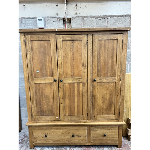 2 - A modern oak triple wardrobe with two lower drawers - approx. 192cm high x 161cm wide x 57cm deep