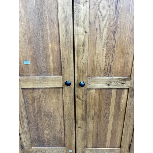 2 - A modern oak triple wardrobe with two lower drawers - approx. 192cm high x 161cm wide x 57cm deep