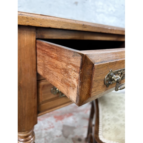 20 - A late 19th century Aesthetic Movement walnut writing desk with two long drawers, two short drawers,... 