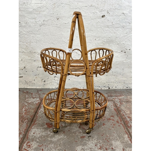 35 - A wicker and bamboo two tier drinks trolley - approx. 77cm high