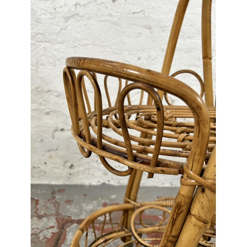 35 - A wicker and bamboo two tier drinks trolley - approx. 77cm high