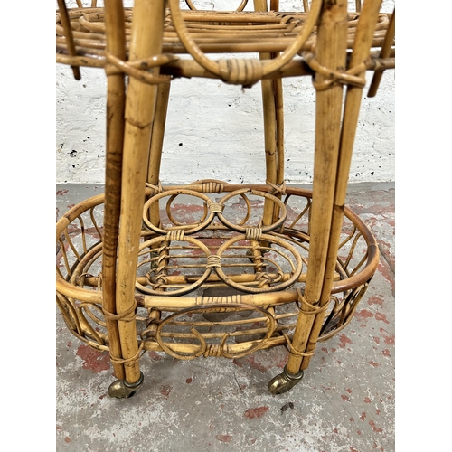 35 - A wicker and bamboo two tier drinks trolley - approx. 77cm high