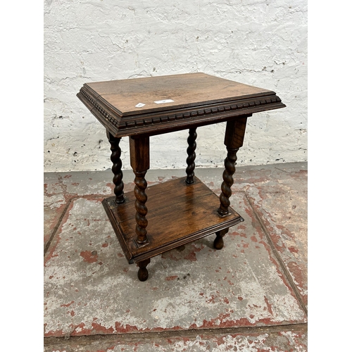 38 - An early 20th century oak two tier side table on barley twist supports - approx. 50cm high x 41cm wi... 