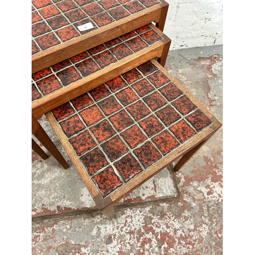 44 - A 1960s BR Gelsted of Denmark teak nest of three tables with red ceramic tile inserts - approx. 48cm... 