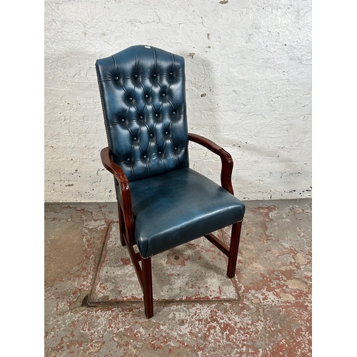 52 - A mahogany and blue leatherette Chesterfield office armchair