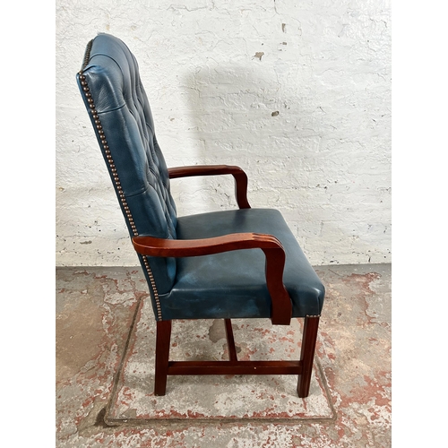 52 - A mahogany and blue leatherette Chesterfield office armchair