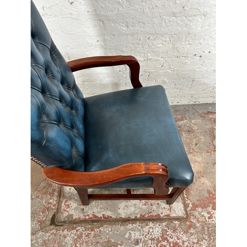 52 - A mahogany and blue leatherette Chesterfield office armchair