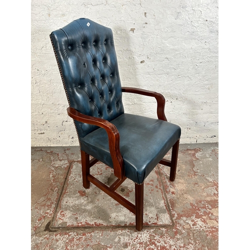 53 - A mahogany and blue leatherette Chesterfield office armchair