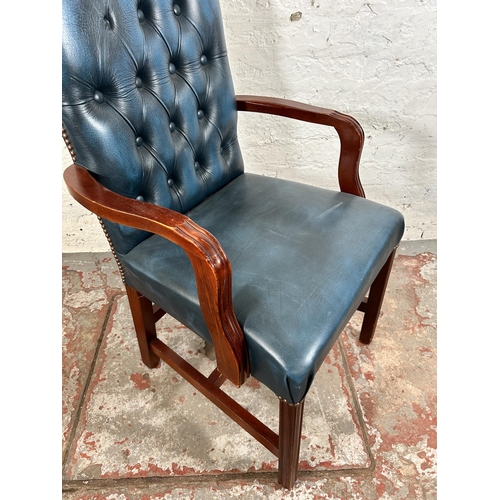 53 - A mahogany and blue leatherette Chesterfield office armchair