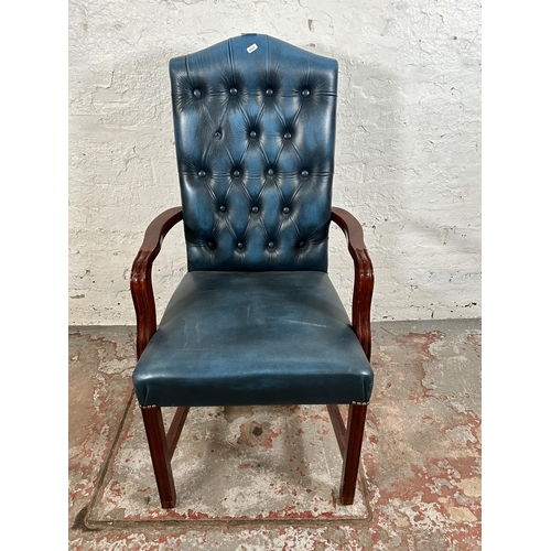 53 - A mahogany and blue leatherette Chesterfield office armchair