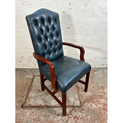 54 - A mahogany and blue leatherette Chesterfield office armchair