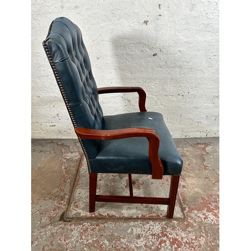 54 - A mahogany and blue leatherette Chesterfield office armchair