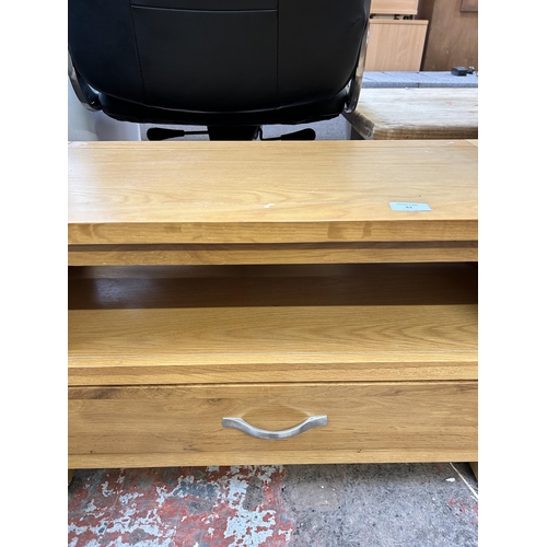 61 - A modern oak TV stand with lower drawer - approx. 46cm high x 75cm wide x 35cm deep