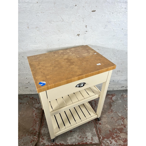 63 - A modern beech and white painted kitchen trolley island with single drawer and two shelves - approx.... 