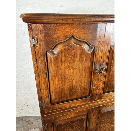 68 - A Royal Oak drinks cabinet with four doors and fitted interior - approx. 139cm high x 86cm wide x 45... 