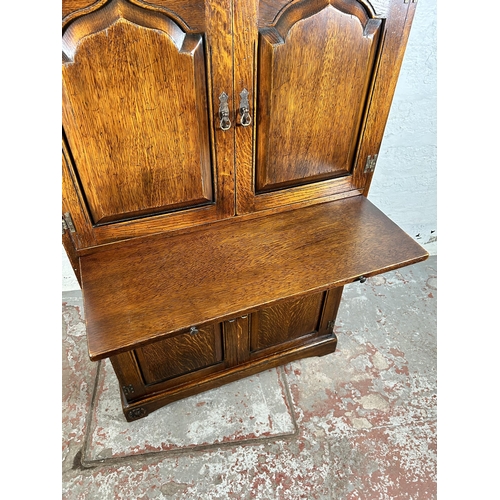 68 - A Royal Oak drinks cabinet with four doors and fitted interior - approx. 139cm high x 86cm wide x 45... 