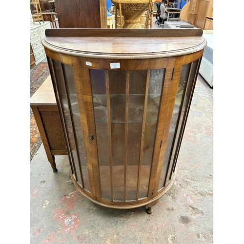 71 - A walnut bow fronted display cabinet with one internal glass shelf