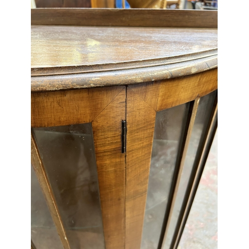 71 - A walnut bow fronted display cabinet with one internal glass shelf