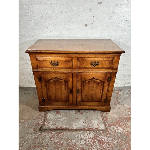 72 - A Royal Oak sideboard with two drawers and two cupboard doors - approx. 84cm high x 96cm wide x 50cm... 