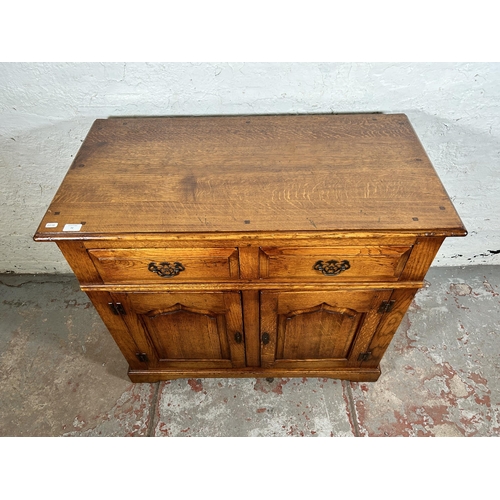 72 - A Royal Oak sideboard with two drawers and two cupboard doors - approx. 84cm high x 96cm wide x 50cm... 