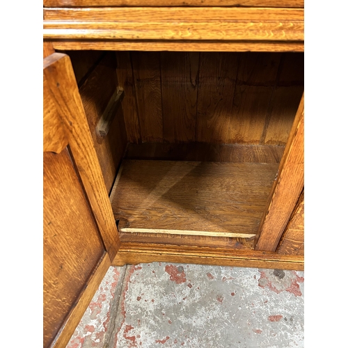 72 - A Royal Oak sideboard with two drawers and two cupboard doors - approx. 84cm high x 96cm wide x 50cm... 