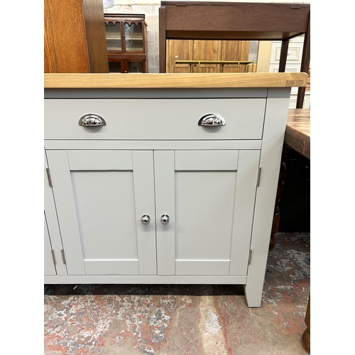 76 - A modern oak and grey painted sideboard with two drawers and four cupboard doors - approx. 91cm high... 