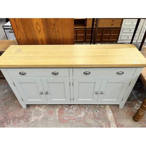 76 - A modern oak and grey painted sideboard with two drawers and four cupboard doors - approx. 91cm high... 