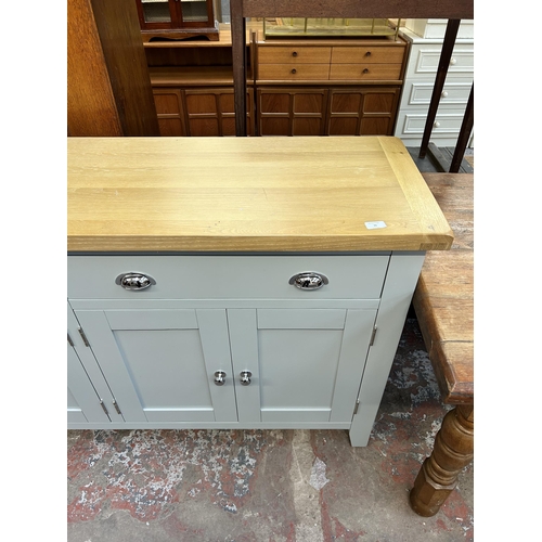 76 - A modern oak and grey painted sideboard with two drawers and four cupboard doors - approx. 91cm high... 