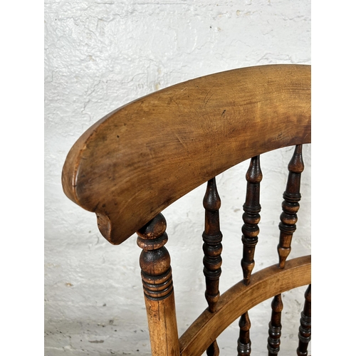 78 - A 19th century beech spindle back armchair with rush seat