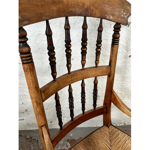 78 - A 19th century beech spindle back armchair with rush seat