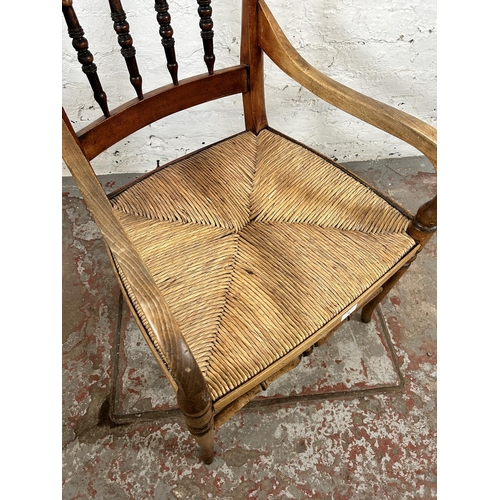 78 - A 19th century beech spindle back armchair with rush seat