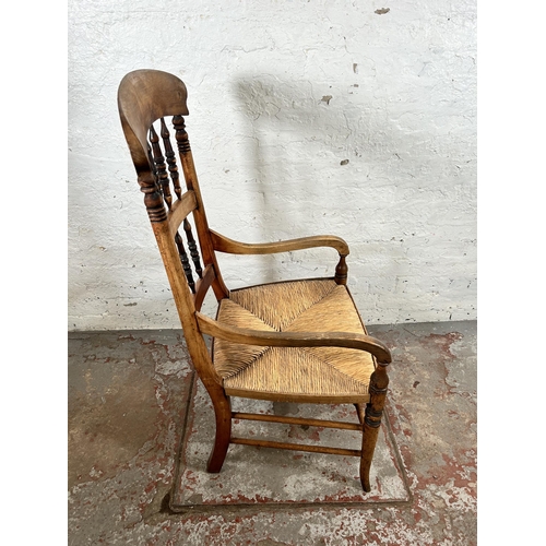 78 - A 19th century beech spindle back armchair with rush seat