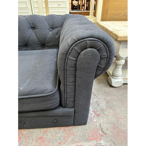 79 - A modern black fabric upholstered armchair