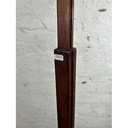 8 - An Art Deco oak standard lamp - approx. 156cm high