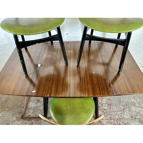 90 - A G Plan tola wood and black painted dining table and three matching chairs