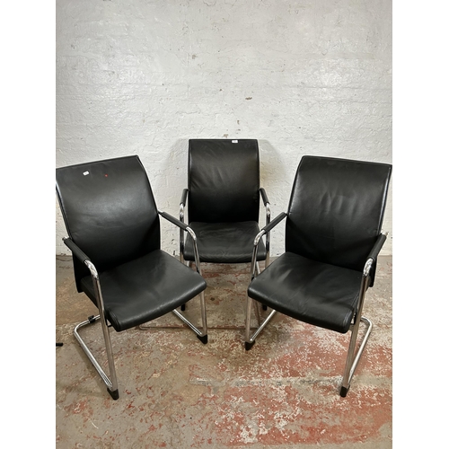 116 - Three modern black leatherette and tubular metal office armchairs