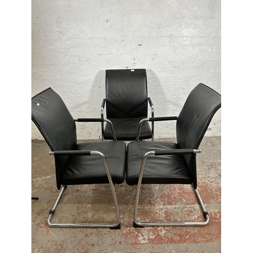 116 - Three modern black leatherette and tubular metal office armchairs