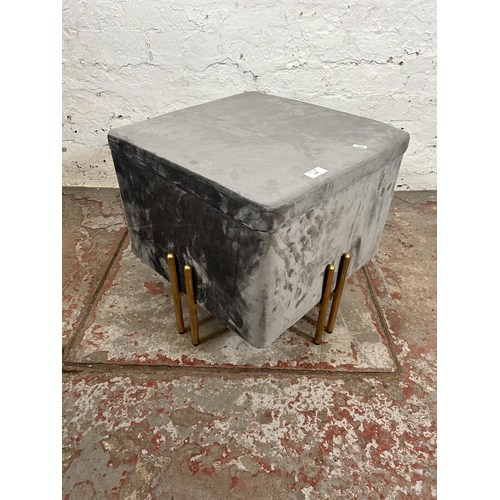 118 - A modern grey fabric storage stool with gold painted supports