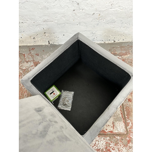 118 - A modern grey fabric storage stool with gold painted supports