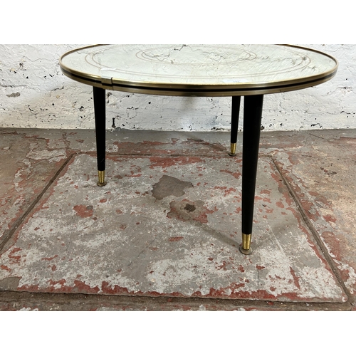 121 - A mid 20th century mirrored glass circular side table with three black painted splayed supports - ap... 