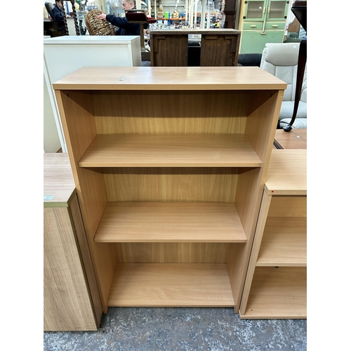 124 - Four pieces of modern office furniture, two beech effect bookcases, one beech effect two door cabine... 