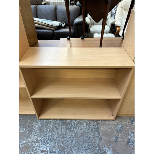 124 - Four pieces of modern office furniture, two beech effect bookcases, one beech effect two door cabine... 