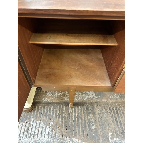 128 - A mid 20th century Nathan teak sideboard with three central drawers and two outer cupboard doors - a... 