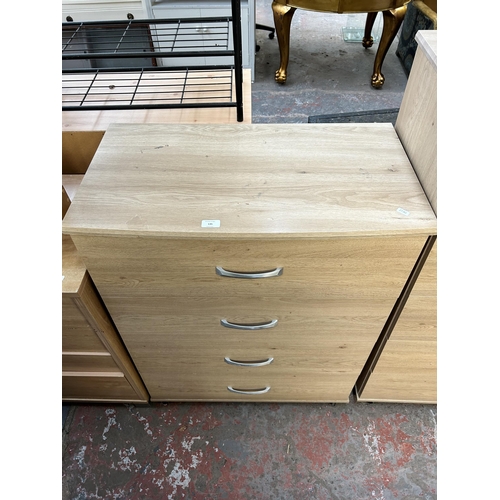 135 - A modern oak effect chest of four drawers - approx. 100cm high x 78cm wide x 41cm deep