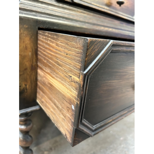 139 - A Jacobean style geometric carved oak bureau with two short drawers, one long drawer, fall front and... 