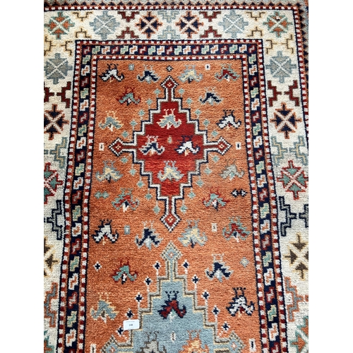 148 - A Persian style multicoloured rug - approx. 155cm long x 89cm wide