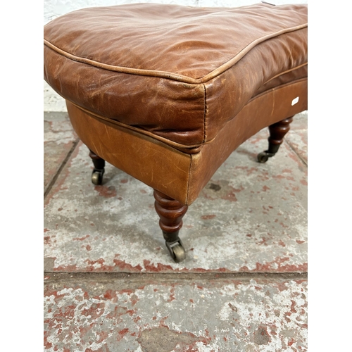 161 - A Gladstone tan leather footstool with brass castors - approx, 42cm high x 63cm wide x 52cm deep