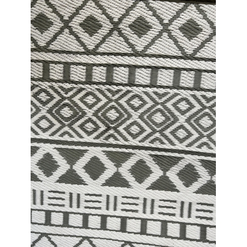 165 - A modern grey and white plastic wicker effect outdoor rug - approx. 240cm long x 159cm wide